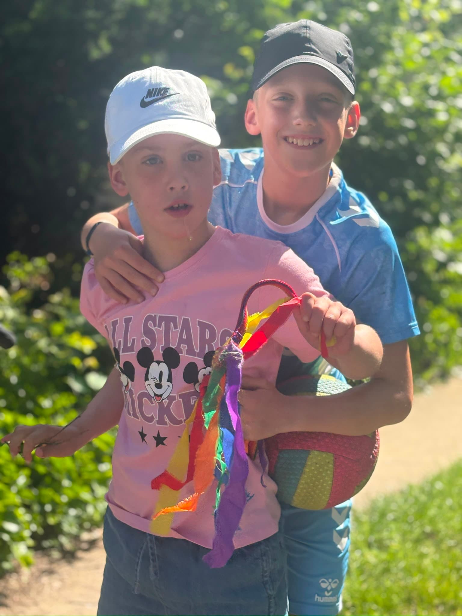 A child and family member smiling together outdoors